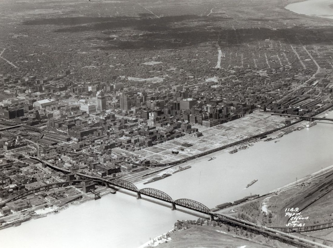 AFTER CLEARING THE RIVERFRONT, 1941
"Nearly 40 blocks totaling more than 50 million square feet of business space were destroyed for the Jefferson National Expansion Memorial. These demolished streets and structures made up most of St. Louis's original village from 1764 and were among the city's most historically significant." &#151; Andrew Wanko, 'Great River City'
Aerial view of St. Louis riverfront, showing progress on demolition of the Jefferson National Expansion Memorial site. 7, May 1941. Photograph by P.R. Papin Aerial Surveys, 1941. Missouri Historical Society Collections