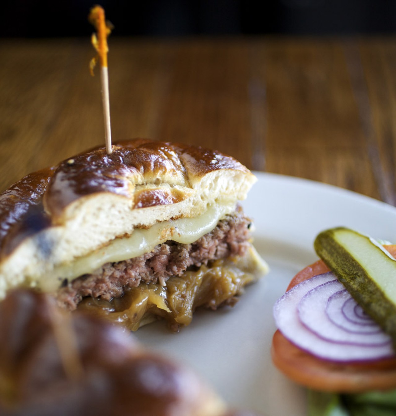 The Pretzel Melt - 1/3 pound hand-pattied burger with provolone & caramelized onions on a pretzel roll.