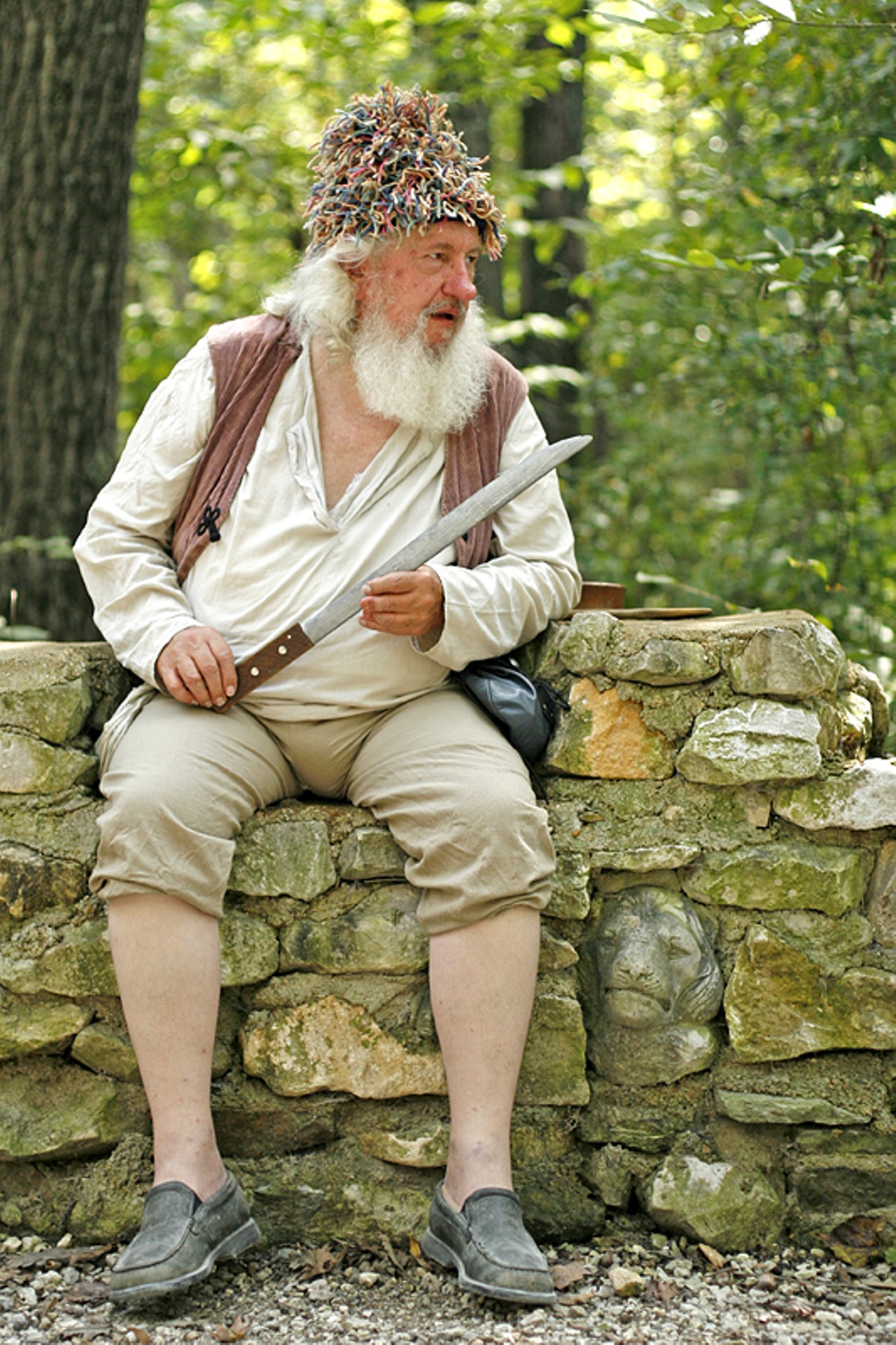 John Rochard, carpenter of the pirate ship, sits on a rock wall watching out for the "real" pirates, or the English men. "We're just honest working men trying to make a living," Rochard said in his defense.