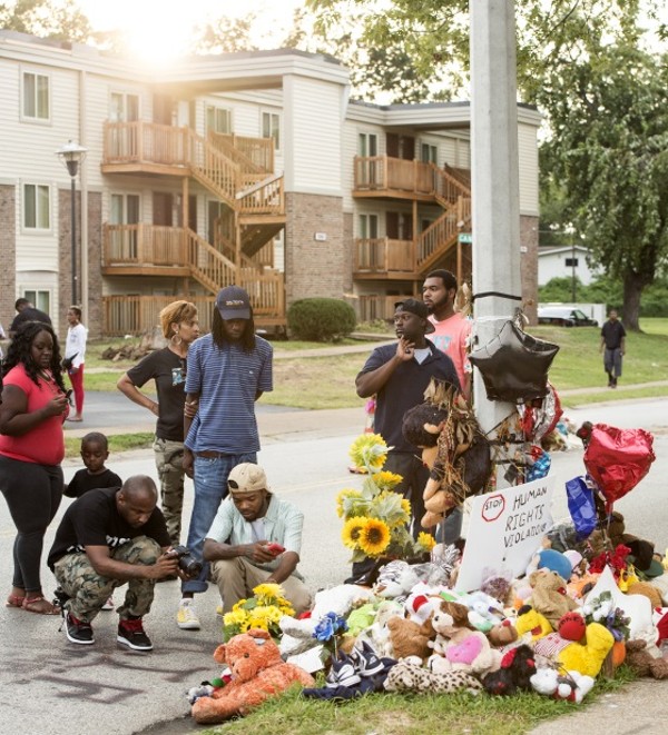 The spot where Michael Brown died became a memorial and gathering place for protesters. - R. GINO