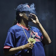 Here's Snoop Dogg Smoking a Blunt in an Ozzie Smith Jersey at LouFest