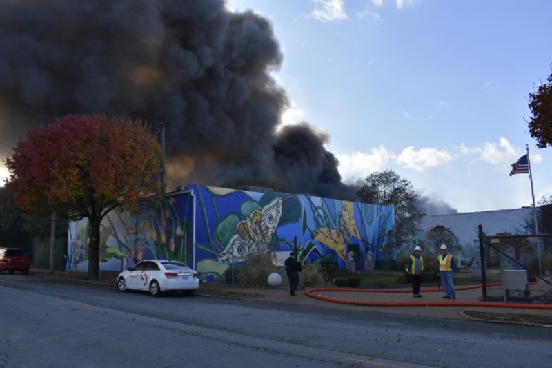 Smoke pours over the neighborhood from a warehouse fire in Botanical Heights. - PHOTO BY DOYLE MURPHY