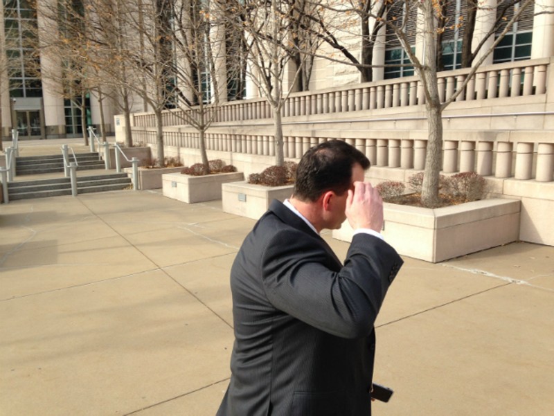 William Cafarella dodges the camera in December 2016 as he leaves federal court. - Photo by Doyle Murphy