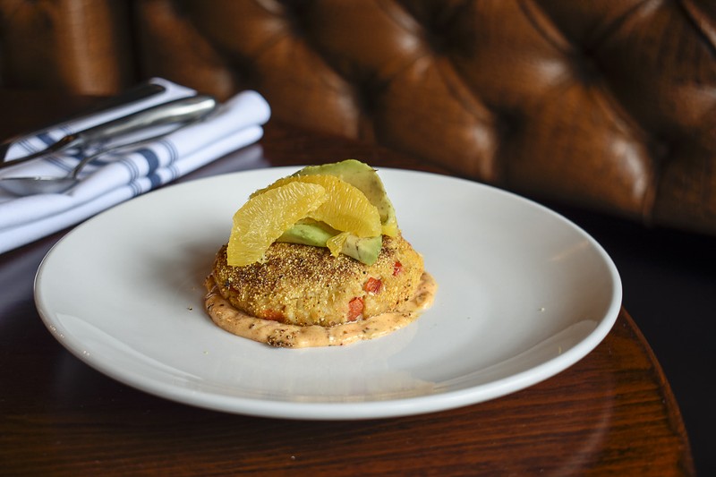 The lump crab cake is topped with avocado and blood orange. - KELLY GLUECK