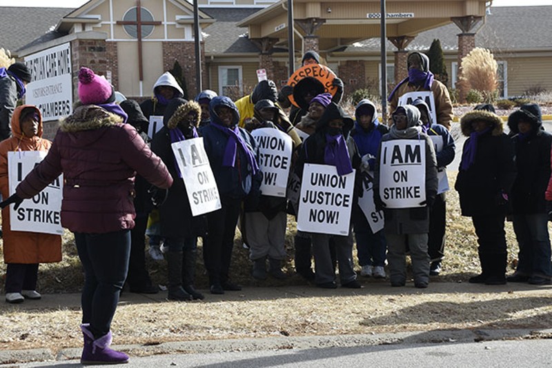 A group of workers from Christian Care Home and community members gathers outside of the facility to protest unfair labor laws. - Megan Anthony