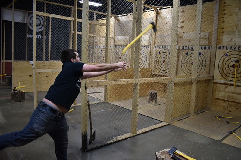 Aaron Cockrell, STL Axe Throwing's owner, shows how it's done. - PHOTO BY DANIEL HILL