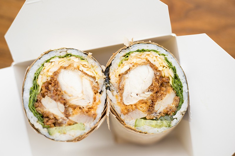 The "Tasty As Cluck" roll includes fried chicken, kimchi slaw, arugula, pickles, crispy shallots, tempura crunch and "OG Fire" sauce. - MABEL SUEN