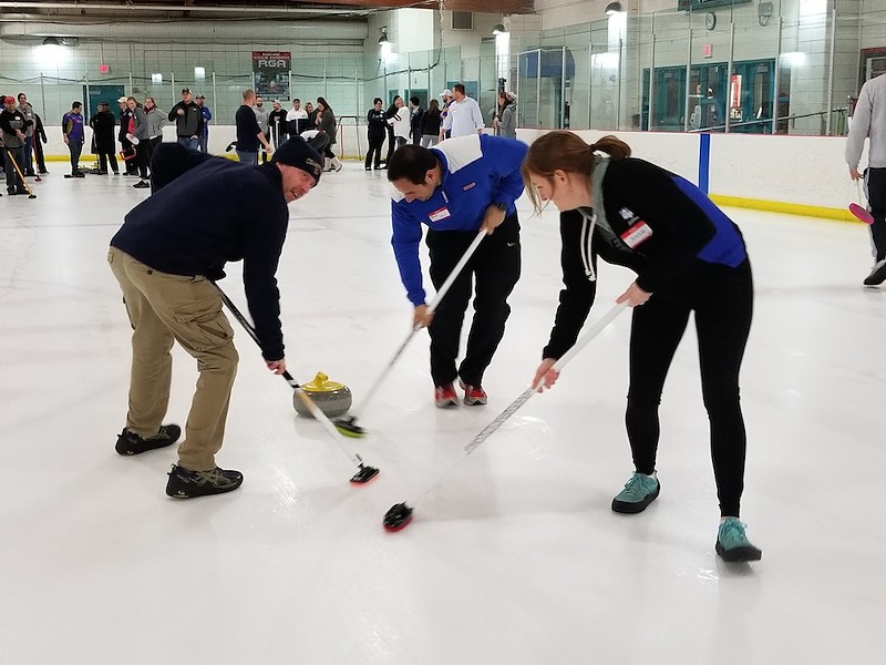 Curling novices sweep the ice in front of the granite stone during an instructional group session from the St. Louis Curling Club. - ALLISON BABKA