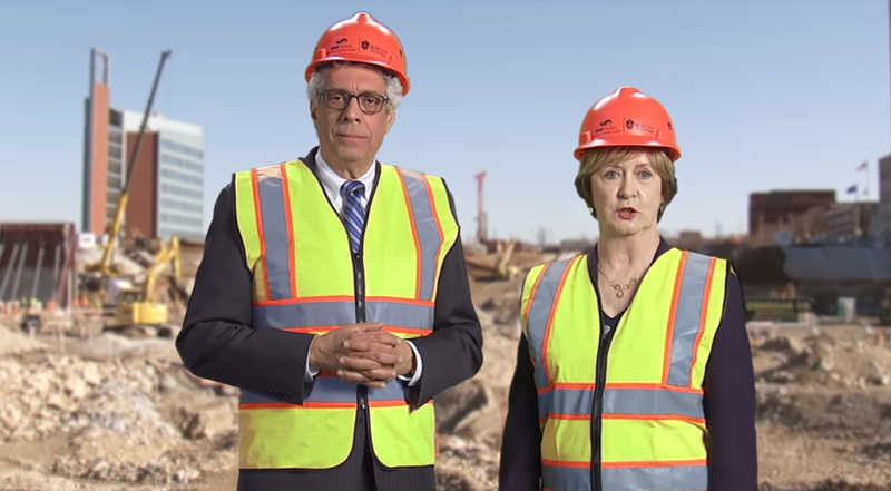 Saint Louis University President Fred Pestello and SSM Health Region President Candace Jennings doing their best to look like they're not standing in front of a green screen. - SCREENSHOT FROM THE VIDEO BELOW