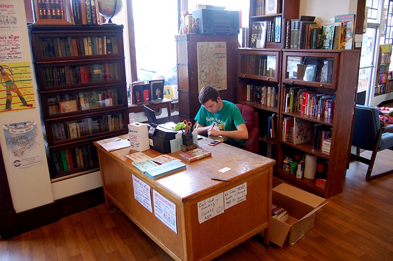 Mark Gould works the front desk at the Book House. - HARLAN MCCARTHY
