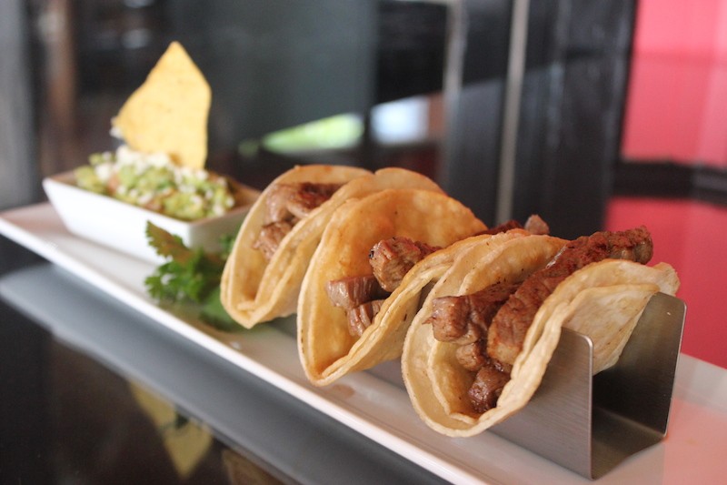 Street tacos are made with tender flank steak and served with cilantro, lime and a side of guacamole. - SARAH FENSKE