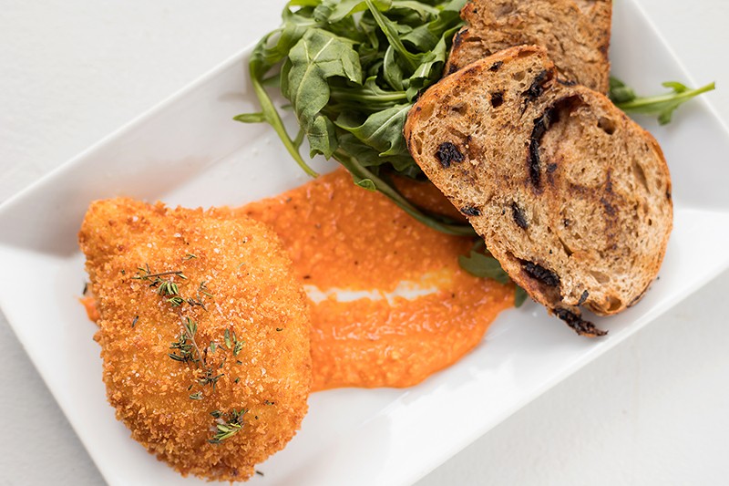 Burrata is breaded and fried and served over romesco sauce. - MABEL SUEN