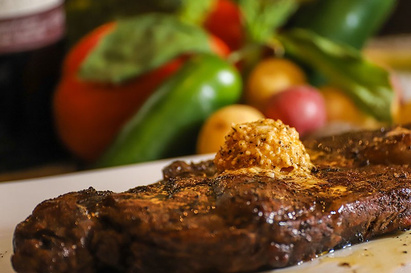 Steaks can be topped with house butters including garlic and herb, bleu cheese and garlic Parmesan. - GLENN REIGELMAN