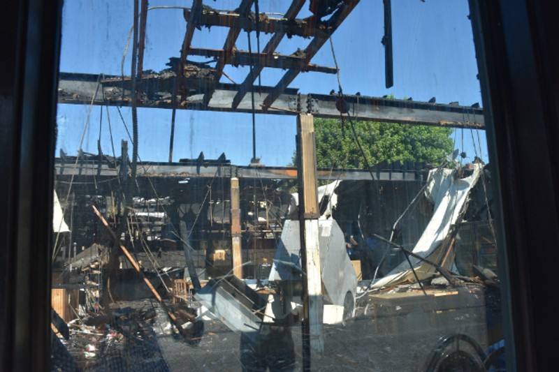 A view through the window of Macklind Avenue Deli shows the damage. - DOYLE MURPHY