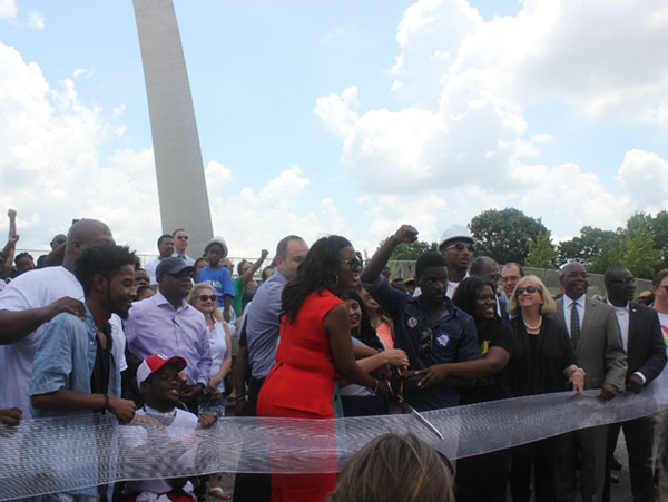 A diverse crowd cuts the ribbon on the Arch renovations - ALISON GOLD