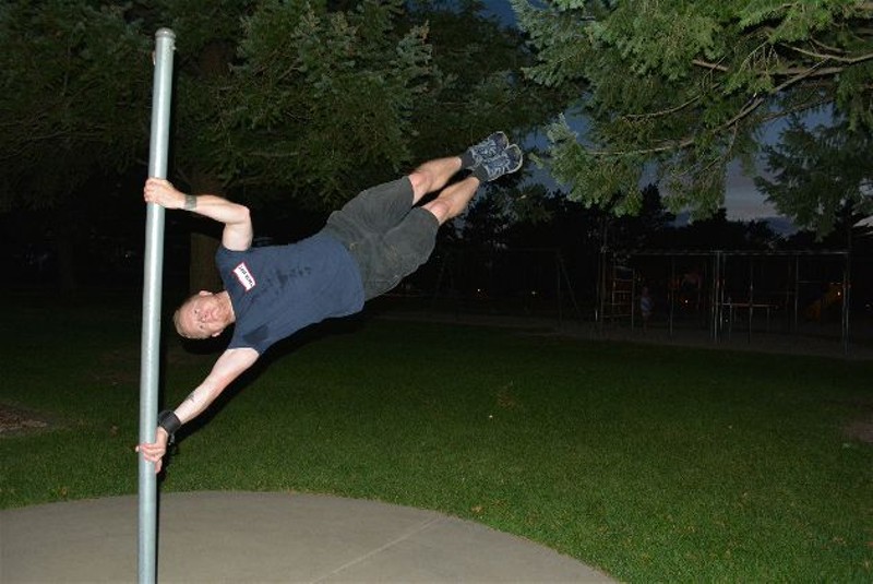 Jake Night displays some of the athleticism inherent in pole dancing on the family's backyard pole. - PROVIDED BY THE FAMILY