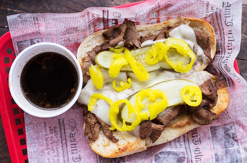 The house-smoked roast beef sandwich is topped with Provel and pickles. - MABEL SUEN