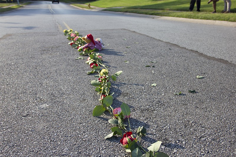 A line of roses arranged on portion of street where Brown was killed. - DANNY WICENTOWSKI