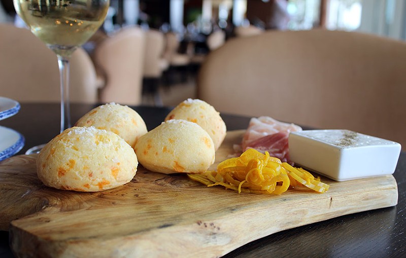 The "Dia's Cheese Bread" served on a board with prosciutto, pickled shallots and lardo. - LEXIE MILLER