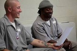 Melton and Williams rehearse with PPA during their free time. The grey jumpsuits are standard-issue for inmates at MECC. - Courtesy of Prison Performing Arts