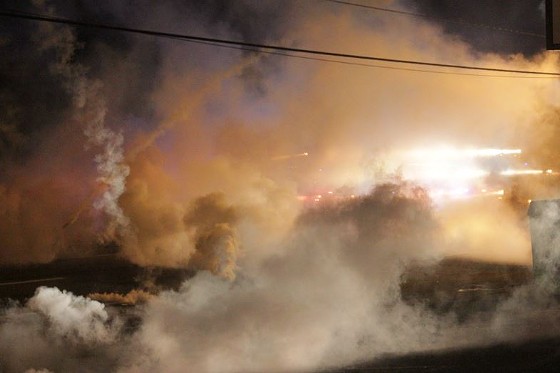 Police fired volleys of tear-gas canisters, flash-bang grenades and smoke bombs Sunday night. - DANNY WICENTOWSKI