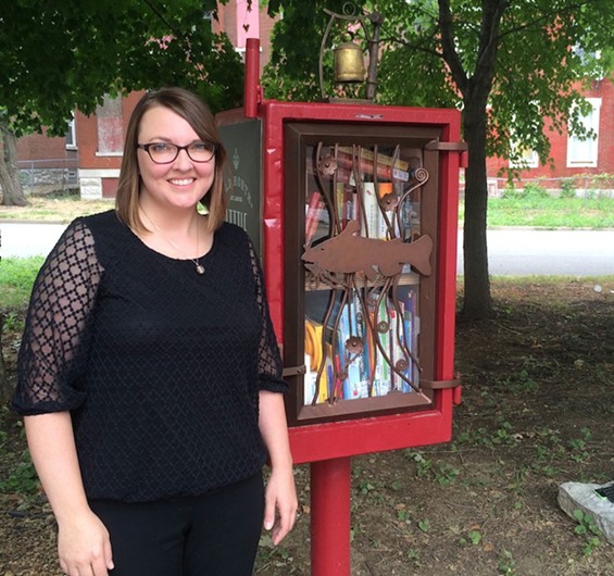 Gina Sheridan stands next to the free library she helped established in an Old North St. Louis park.