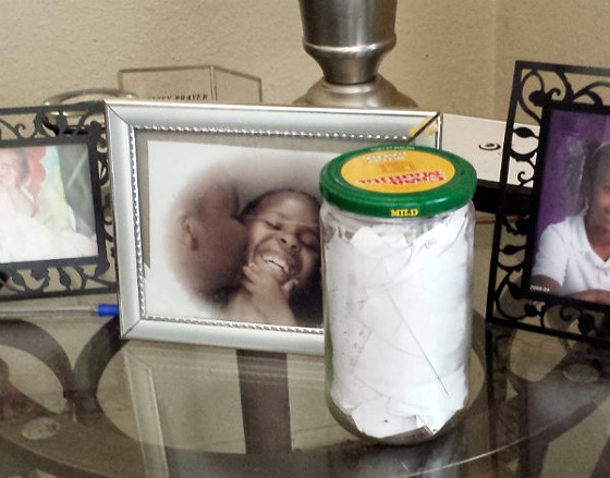 A photo of Mike Brown as a little boy, being kissed by one of his siblings. To the right is a jar he filled with rap lyric ideas. - Jessica Lussenhop