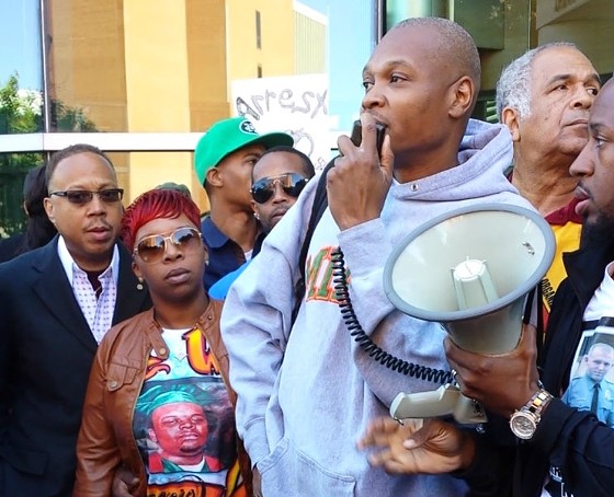 Eric Davis addresses a rally in Clayton in September with Michael Brown's mother, Lesley McSpadden. - Jessica Lussenhop