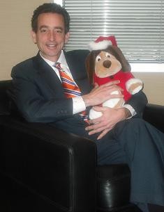 Attorney Al Watkins with a Santa Paws toy.