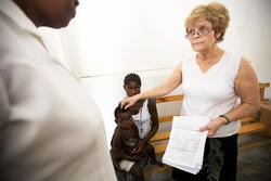 Dr. Pat Wolff confers with nurse Marie Fleurese Gourges over a Haitian medika mamba patient. - Jennifer Silverberg