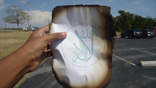 A burned page of a Koran recovered from the blaze that destroyed Joplin's mosque. - Facebook/Islamic Society of Joplin