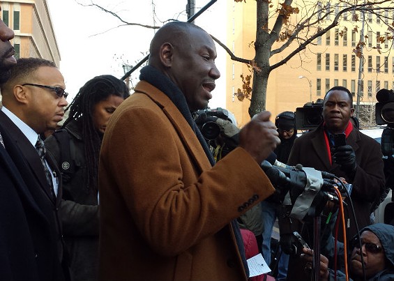 Brown family attorney Benjamin Crump, center, and attorney Anthony Gray, left, address the media. - Jessica Lussenhop