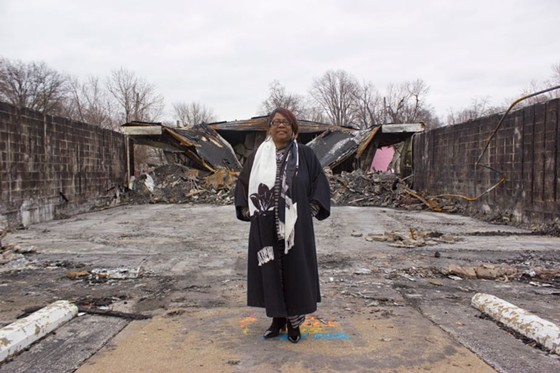 Juanita Morris stands in front of the remains of her store, Fashion R Boutique, which was burned down in the rioting over Michael Brown's death. - ALL PHOTOS BY DANNY WICENTOWSKI