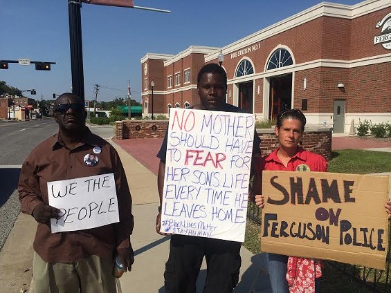 Louis Wilson, left, protests outside the Ferguson Police Department. - Mitch Ryals