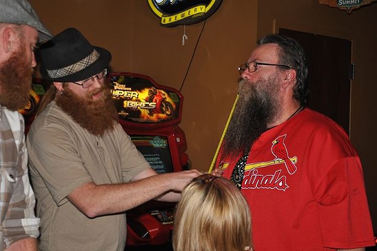 Richie Darling measures a club member's beard. - St. Louis Beard and Mustache Club