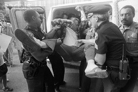 An anti-abortion protester gets carried into the paddy wagon at a protest in Atlanta. - Image via