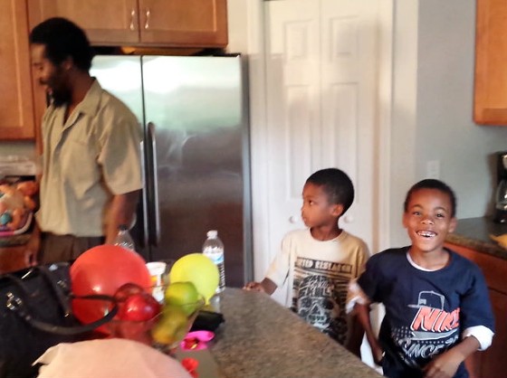 Here is what a kid's face looks like moments after realizing his dad is home from prison (Mike Anderson at left). - Jessica Lussenhop