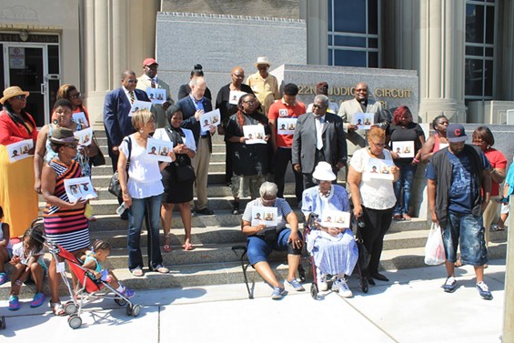 Family and supporters of Anthony Williams pray outside the Circuit Court building. - Ray Downs