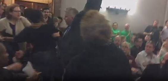 Jeff Roorda, police union business manager, grabs Cachet Currie's arm as the scuffle begins. - via Ustream