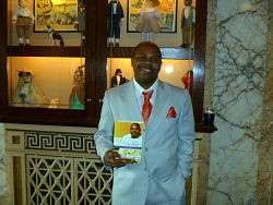 Dwayne L. Buckingham shows off his new book Qualified, Yet Single and his excellent fashion sense in the lobby of the Tivoli Theatre.