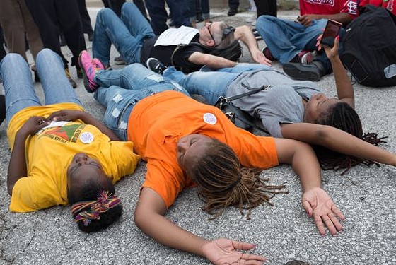 Some protesters lay down in the middle of the road near the I-70 off ramp. They were arrested. - Bryan Sutter