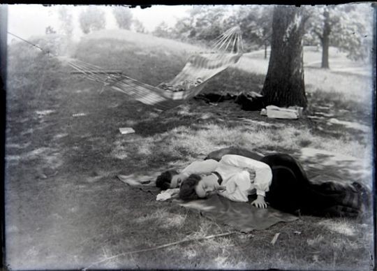Two women take a nap in a St. Louis park circa 1900. - Courtesy of John Foster