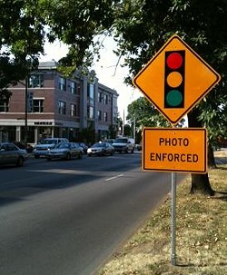 A sign alerts drivers of new cameras at Skinker and Forest Park Parkway.