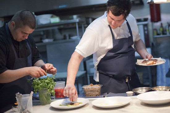 Owner and chef Mike Randolph plating a dish at MEDIAnoche - Crystal Rolfe