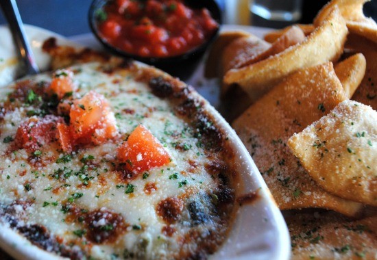 Spinach artichoke dip from Cicero's in all its bubbly goodness, with a side of marinara. - Julia Gabbert
