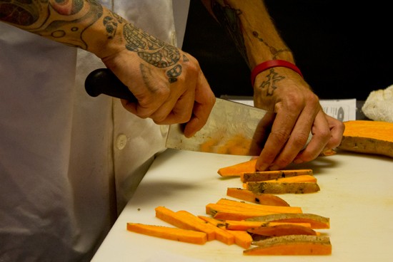 Sous chef David Anderson hand cuts sweet potato fries. - Mabel Suen