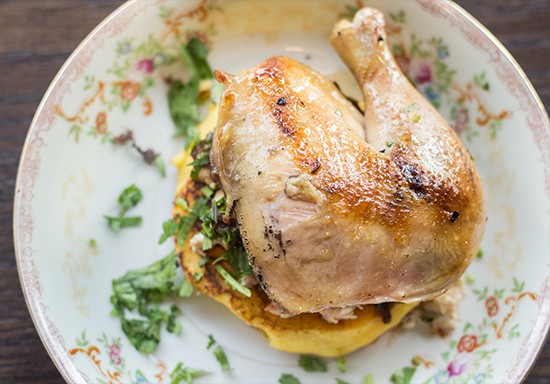 An arepa, a leavened corn pancake, topped with smoked Cornish hen. | Photos by Mabel Suen