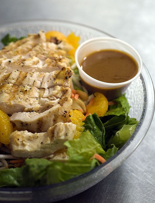 Grilled chicken atop the Thai Chicken Salad, which is comprised of grilled marinated chicken atop crisp romaine, bean sprouts, cashews, mandarin oranges, green onion, carrot and a side of Thai peanut sauce. See more photos here. - Photo: Jennifer Silverberg