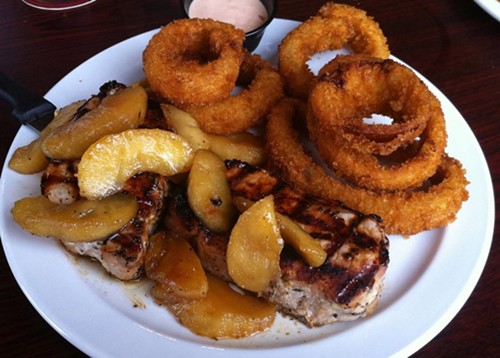 Pork chops with saut&eacute;ed apples at Quincy Street Bistro. - Holly Fann