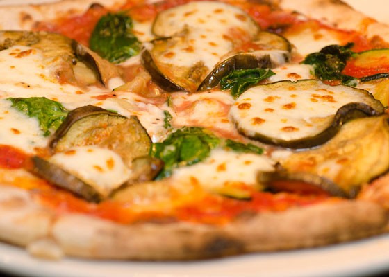 A Neapolitan-style pizza topped with eggplant, zucchini and spinach. | Kurman Communications